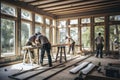 Group of carpenters working in a carpentry workshop on a wooden floor, A team of workers installing windows and doors in a new Royalty Free Stock Photo