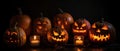 group of carved jack - o\' - lanterns with candles flickering inside, casting spooky shadows Halloween scene Royalty Free Stock Photo