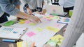 Group of casually dressed business people discussing ideas in the office. Creative professionals gathered at the meeting table for Royalty Free Stock Photo