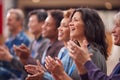 Group Of Casually Dressed Businessmen And Businesswomen Applauding Presentation At Conference Royalty Free Stock Photo