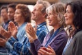 Group Of Casually Dressed Businessmen And Businesswomen Applauding Presentation At Conference Royalty Free Stock Photo