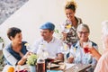 Group of caucasian cheerful happy people together drinking some wine having fun in friendship - different ages generation with Royalty Free Stock Photo