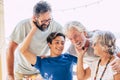 Group of caucasian family people all together have fun and enjoy mixed generations and years old from teenager to adult and senior