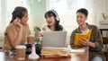 A group of cheerful Asian college students are enjoying talking and discussing their group project Royalty Free Stock Photo