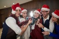 A group of cheerful colleagues celebrating the New Year in the hallway at work and posing for a photo. Together, New Year,