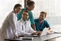 Group of cheerful diverse doctors laughing at laptop Royalty Free Stock Photo