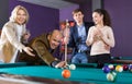 Group of cheerful friends playing billiards and smiling Royalty Free Stock Photo