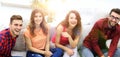 Group of cheerful friends watching videos, sitting on the couch Royalty Free Stock Photo