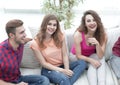 Group of cheerful friends watching videos, sitting on the couch Royalty Free Stock Photo