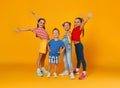 Group of cheerful happy children on colored yellow background