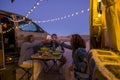 Group of cheerful happy and free people friends celebrate together toasting in outdoor adventure van vehicle travel vacation -