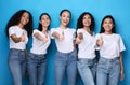 Group Of Cheerful Ladies Gesturing Thumbs-Up On Blue Studio Background