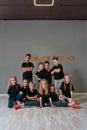 Hip hop dancers. Group of happy little boys and girls in black sweatshirts posing together in the dance studio. Dance Royalty Free Stock Photo