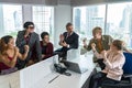 Group of cheerful multiethnic business people, company staff, and workers in a modern office Royalty Free Stock Photo