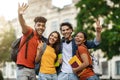 Group Of Cheerful Multietnic College Friends Posing Together Outdoors