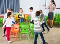 School kids playing active games with teacher