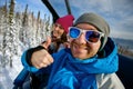 Group cheerful snowboarders on the mountain resort