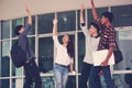 Group of cheerful students with raised hands in the campus, Stu Royalty Free Stock Photo