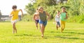 Group of cheerful tweens running together in city park