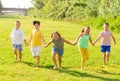 Group of cheerful tweens running together in city park