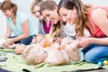 Group of cheerful women learning to take care of their babies Royalty Free Stock Photo