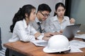 Group of cheerful young Asian business people working together on a laptop computer at office. Teamwork brainstroming concept. Sel Royalty Free Stock Photo