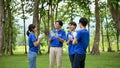 A group of cheerful young Asian volunteers clapped hands to celebrate their successful charity event Royalty Free Stock Photo