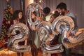 Friends holding balloons shaped as numbers 2022 representing the upcoming New Year Royalty Free Stock Photo