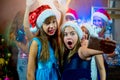 Group of cheerful young girls celebrating Christmas. Selfie Royalty Free Stock Photo