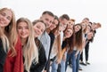 Group of cheerful young people standing behind each other