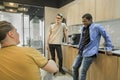 Group of cheerful young people talking and smiling during coffee break time in the office. Team of professional software Royalty Free Stock Photo