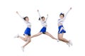 Group of cheerleader girls jumping together on studio Royalty Free Stock Photo