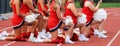 Group of Cheerleaders Kneeling on a Track Royalty Free Stock Photo