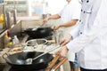 Group of chefs in hotel or restaurant kitchen busy cooking Royalty Free Stock Photo