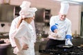 A group of chefs preparing delicious meal in high luxury restaurant.