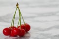 A group cherries on marble background. Royalty Free Stock Photo