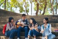 Group of child student playing guitar and singing songs together in summer park Royalty Free Stock Photo