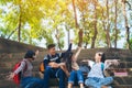 Group of child student playing guitar and singing songs together in summer park Royalty Free Stock Photo