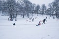 Group of children and adult playing on snow in winter time Royalty Free Stock Photo