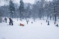 Group of children and adult playing on snow in winter time Royalty Free Stock Photo