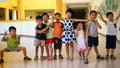 Qingyuan, China - June 23, 2016: 8 Asian kids at the kindergarten having fun and playing with each other