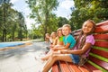 Group of children on the bench in park Royalty Free Stock Photo