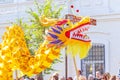 A group of children carry on their hands the construction of a toy of a large dragon at the procession `Festival of Flowers