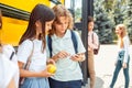 Classmates going to school by bus boy showing girl game on smartphone smiling curious close-up Royalty Free Stock Photo