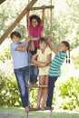 Group Of Children Climbing Rope Ladder To Treehouse Royalty Free Stock Photo