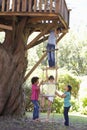 Group Of Children Climbing Rope Ladder To Treehouse Royalty Free Stock Photo