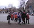 A group of children crossing the road under the supervision of the controller