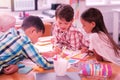 Group of children drawing together in the classroom. Royalty Free Stock Photo
