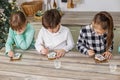 Group children draws food paints on Christmas homemade gingerbread cookies. Christmas concept