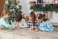 Group children draws food paints on Christmas homemade gingerbread cookies. Christmas concept